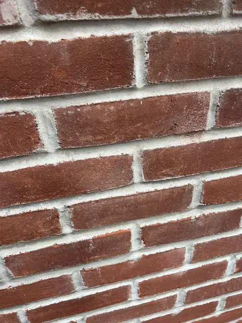Repointed red brick wall