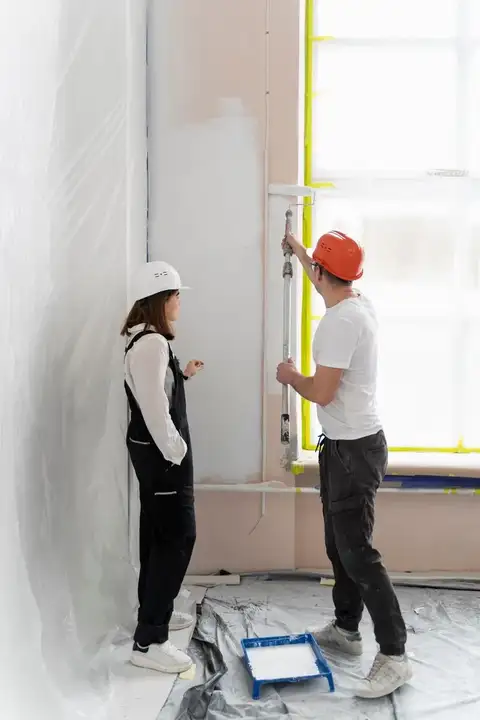 Painters working on an interior wall