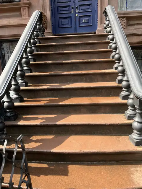 Rebuilt stoop steps leading to a blue front door